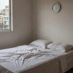 Quarto simples brasileiro com cama e bengala representando risco de mobilidade por sono excessivo em idosos